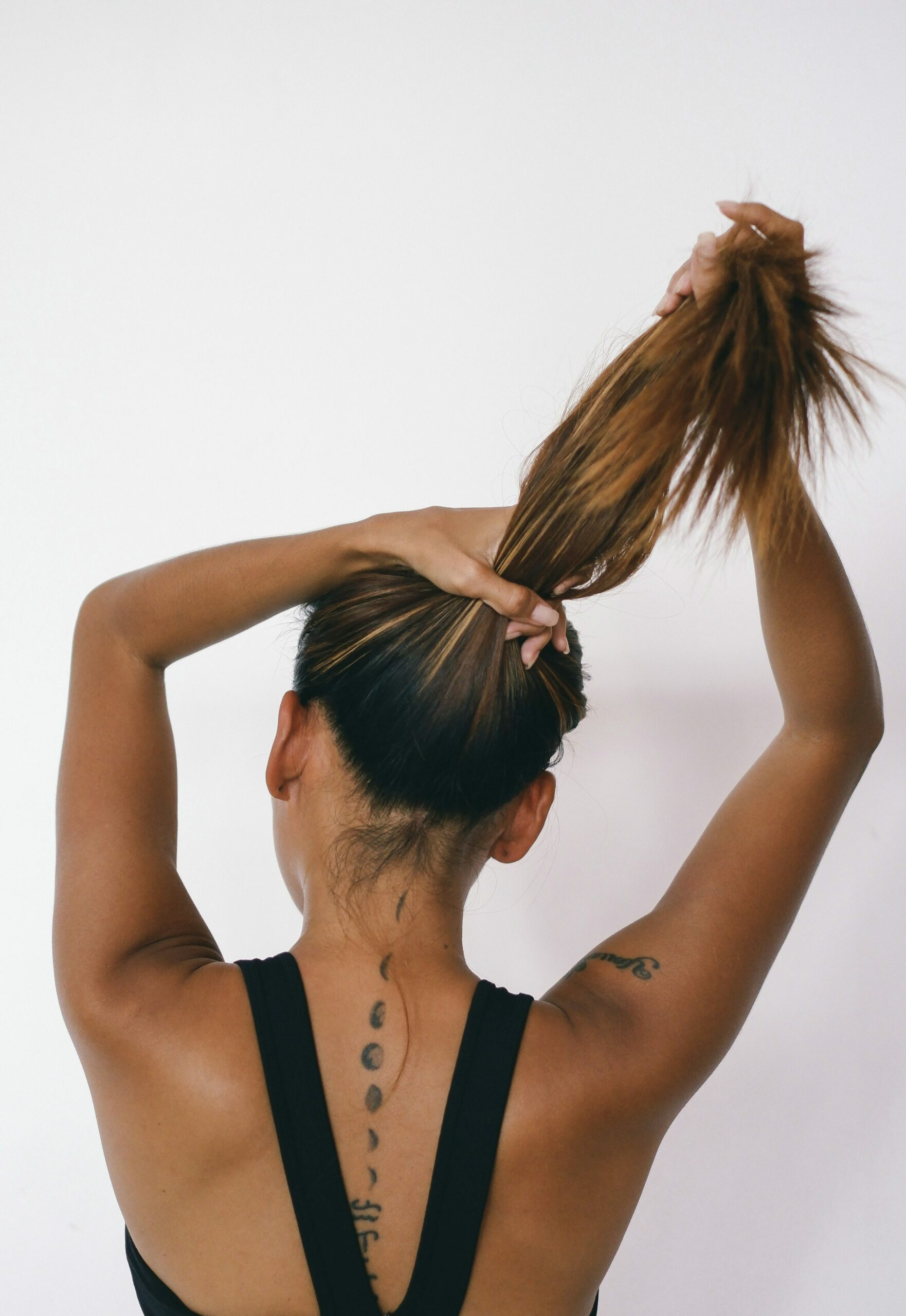 girl tying ponytail